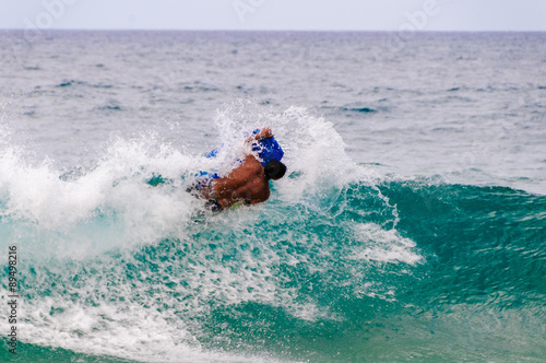 Teenager boogie boarding on the tropical island of Maui, Hawaii,