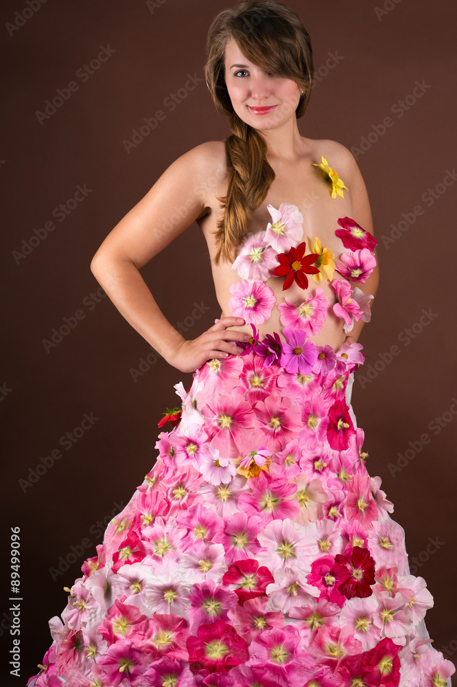 gorgeous woman in a dress from flowers