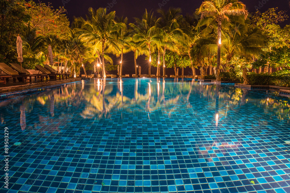 blue swimming pool with light reflections at night
