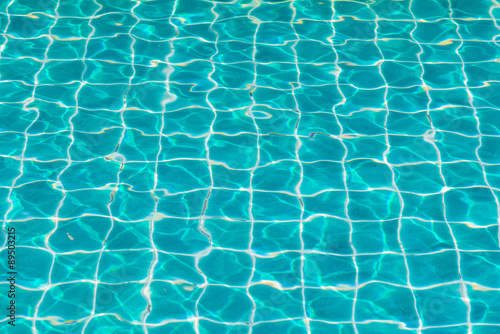 blue swimming pool with sunny reflections.