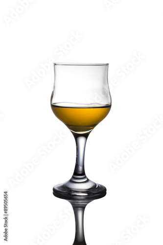 Alcohol in glass on white background.