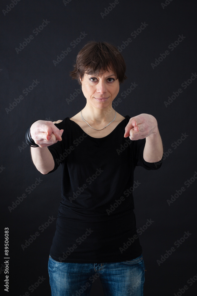 Beautiful woman doing different expressions in different sets of clothes: gun sign Beautiful woman doing different expressions in different sets of clothes: gun sign