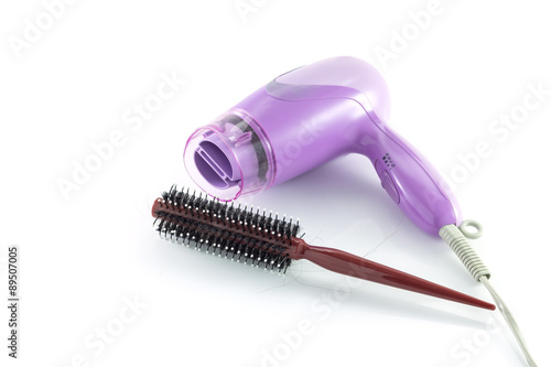 Used rolling comb with hair dryer isolated on white background