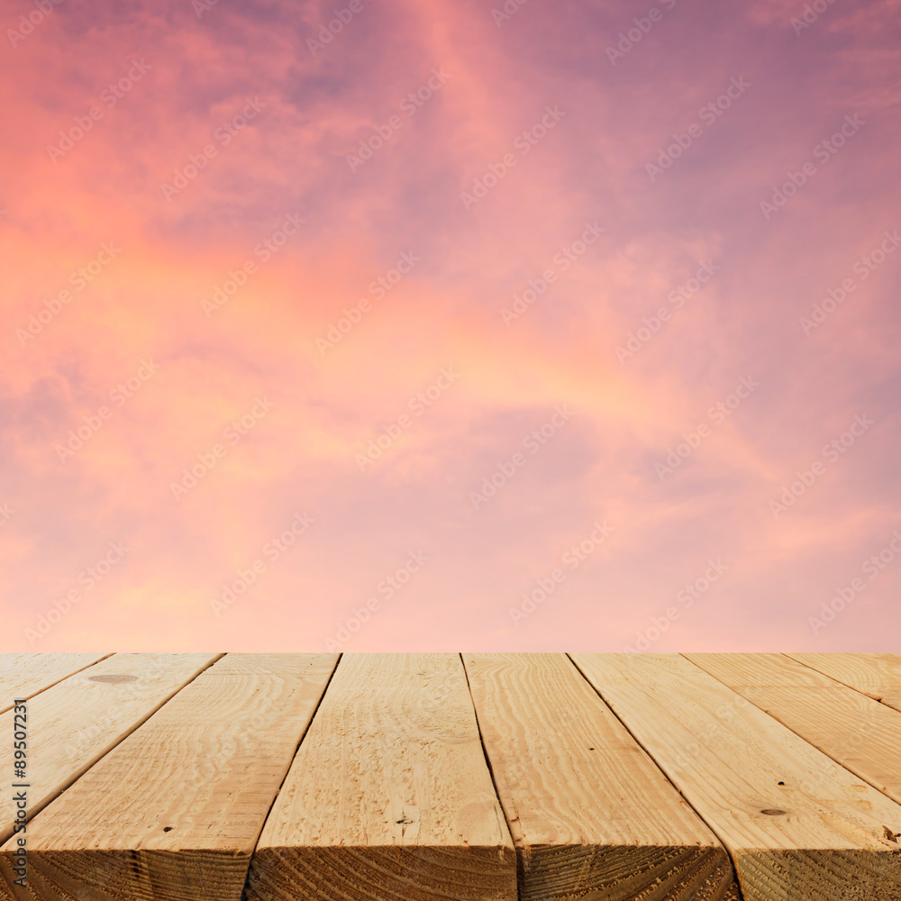 Wooden terrace on sunset background