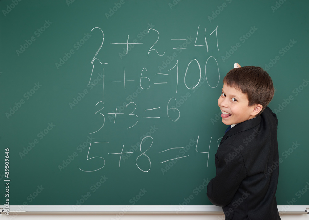 School boy solve math on school board