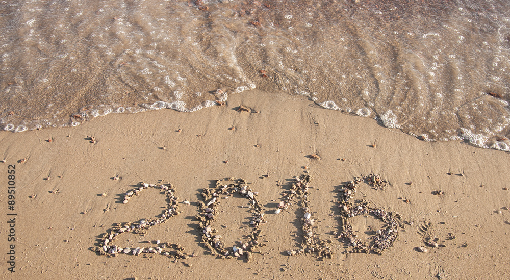 Fototapeta premium 2016 written in sand on sunny beach