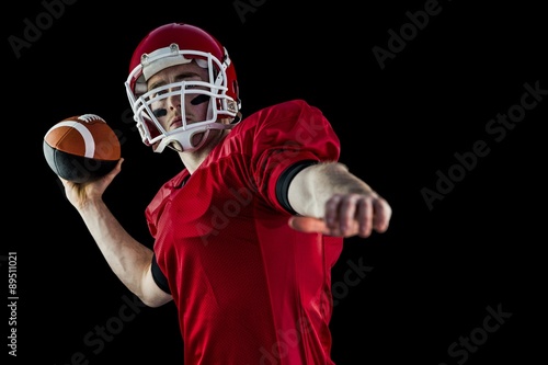 American football player throwing football