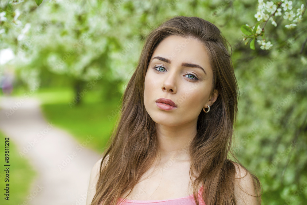 Portrait of beautiful young brunette woman in spring blossom Portrait of beautiful young brunette woman in spring blossom