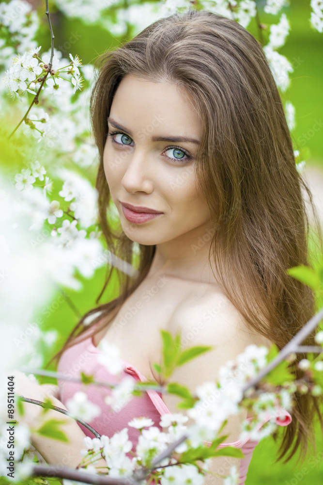 Portrait of beautiful young brunette woman in spring blossom Portrait of beautiful young brunette woman in spring blossom