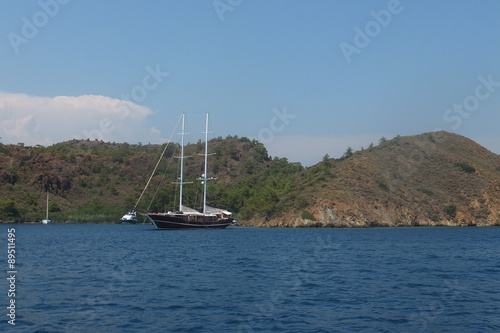The boat near the island in the blue sea, Turkey, Aegean