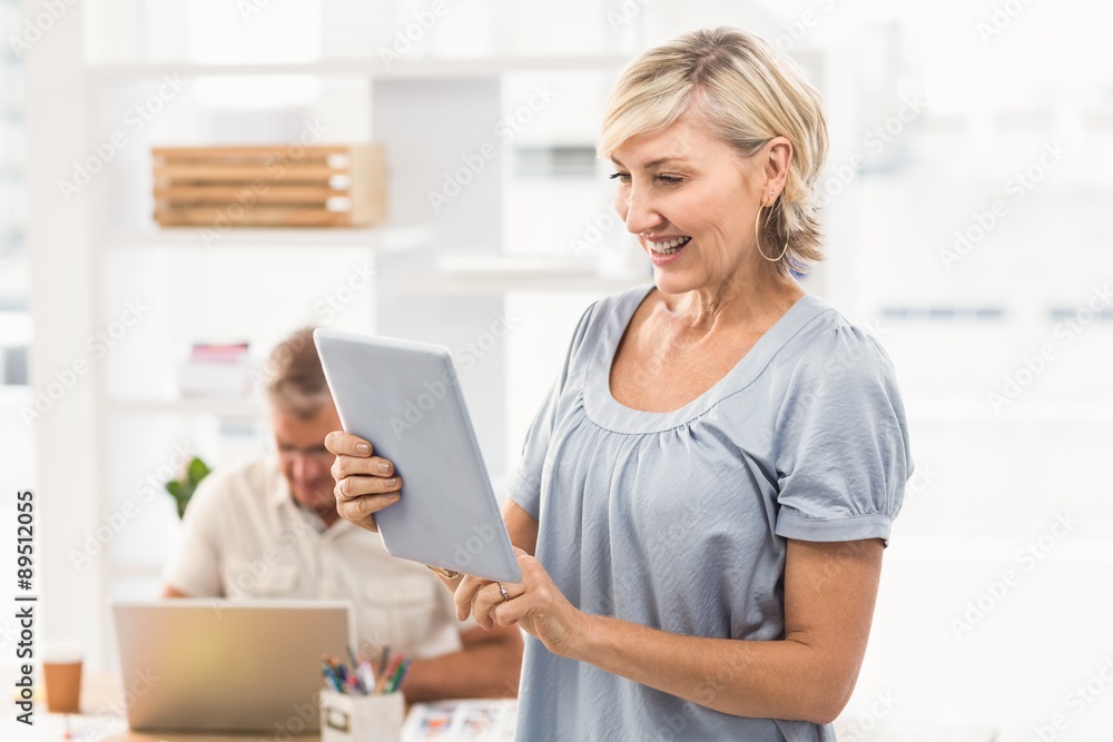 Smiling businesswoman scrolling on a tablet Smiling businesswoman scrolling on a tablet