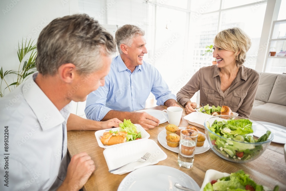 Smiling business people having lunch together