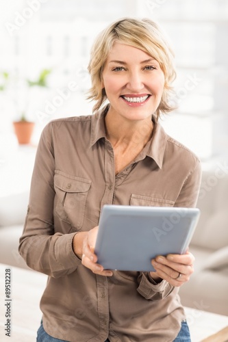 Smiling casual businesswoman with tablet © WavebreakmediaMicro