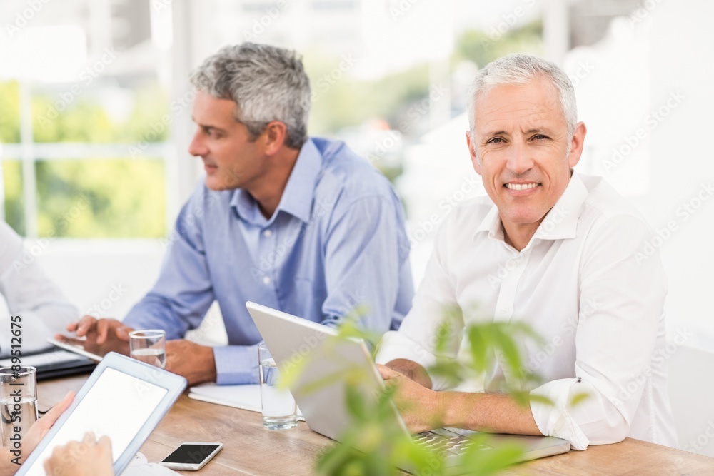 Smiling businessman during a meeting Smiling businessman during a meeting