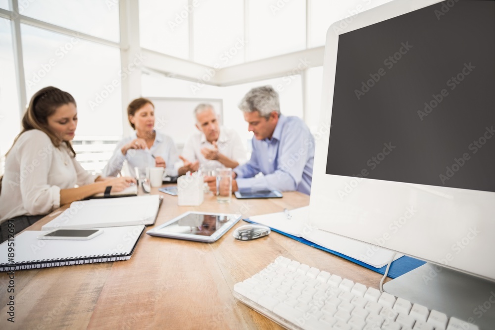 Electronic devices in front of talking business people Electronic devices in front of talking business people