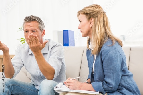 Therapist listening to male patients worries © WavebreakMediaMicro