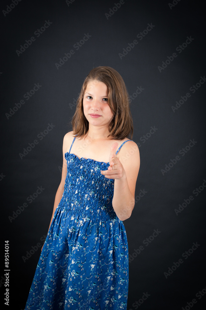 Beautiful girl doing different expressions in different sets of clothes: gun sign Beautiful girl doing different expressions in different sets of clothes: gun sign