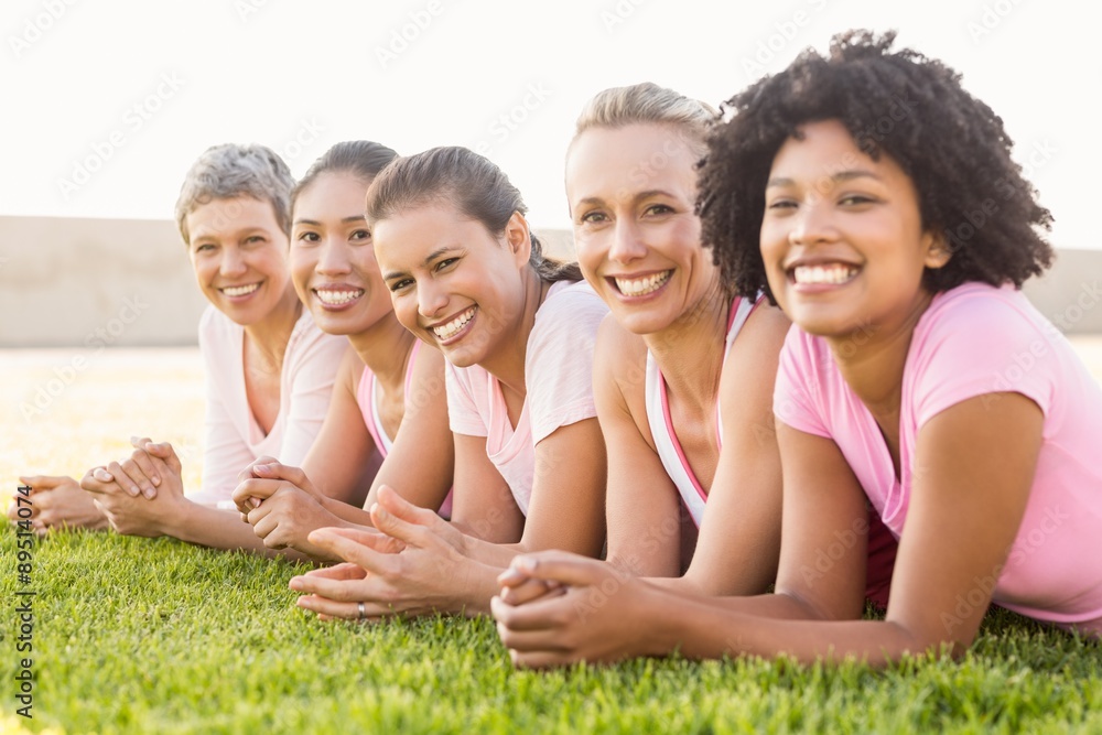 Smiling women lying in a row and wearing pink for breast cancer Smiling women lying in a row and wearing pink for breast cancer