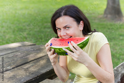 Smiling Young Woman Eating Watermelon
