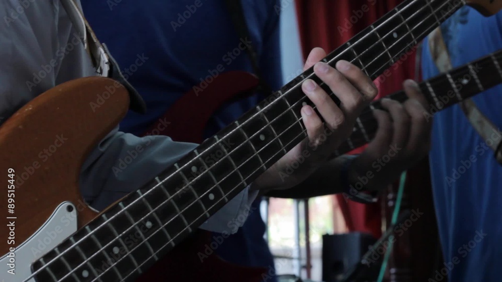closeup man playing electrical guitar bass closeup man playing electrical guitar bass