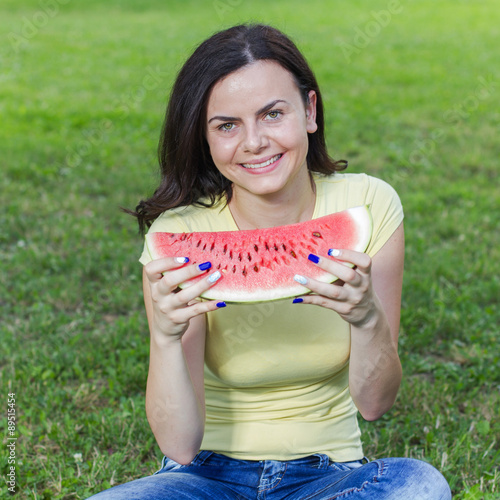 Smiling Young Woman Eating Watermelon