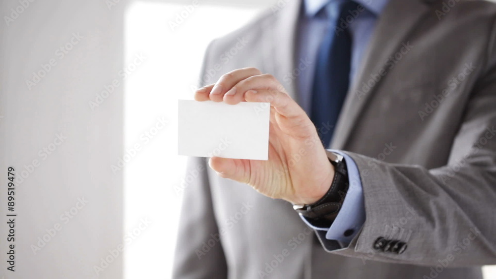 close up of businessman showing white blank card close up of businessman showing white blank card