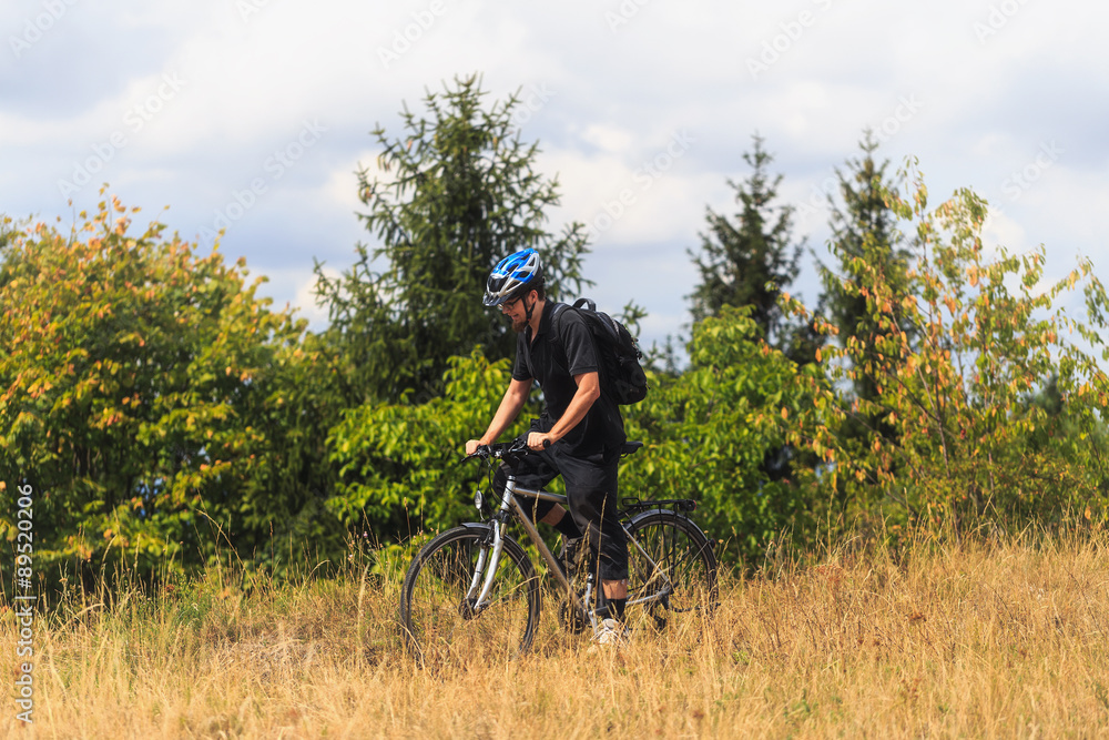 Fototapeta premium Biking in the Franconian Hills in Northern Bavaria. Young man on