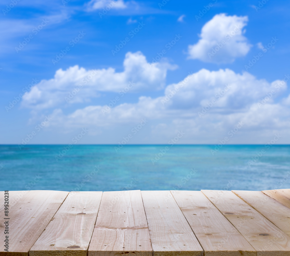 Wood table with blur  seascape and blue sky background