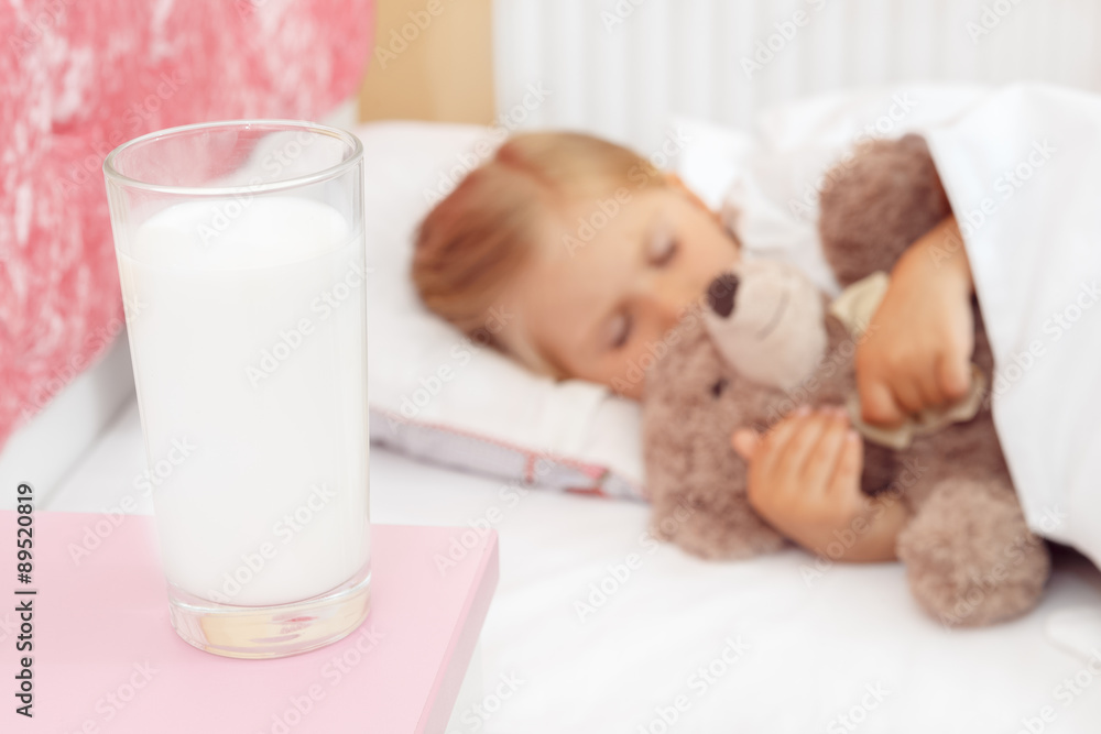 Adorable little girl sleeping in bed with her teddy bear Stock Photo ...