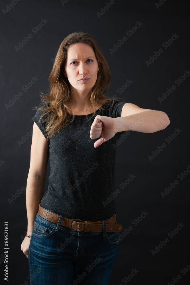 Beautiful woman doing different expressions in different sets of clothes: thumbs down Beautiful woman doing different expressions in different sets of clothes: thumbs down