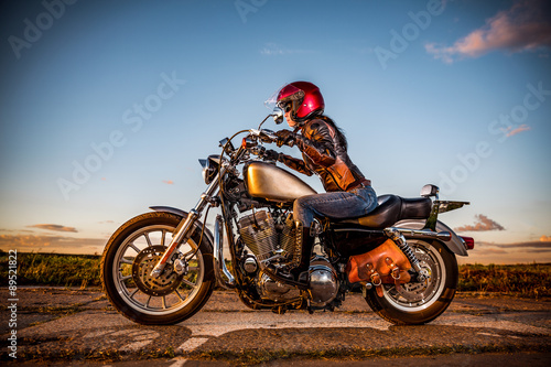 Fototapeta Naklejka Na Ścianę i Meble -  Biker girl on a motorcycle