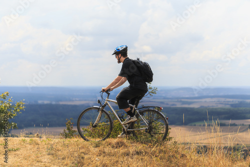Biking in the Franconian Hills in Northern Bavaria. Young man on