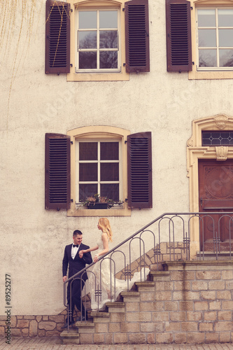 Bridal couple on stairs of their house