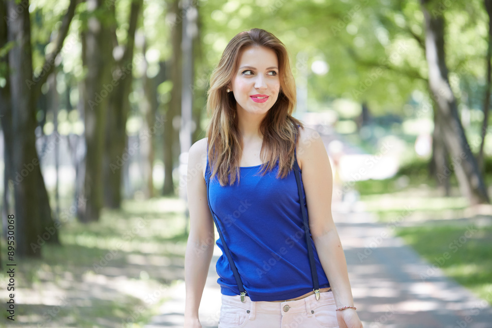 beautiful girl in the park looks into shopping bags beautiful girl in the park looks into shopping bags