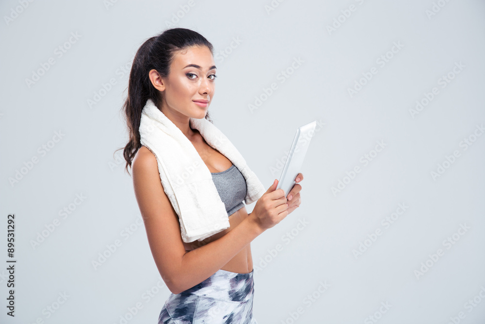 Sports woman using tablet computer Sports woman using tablet computer