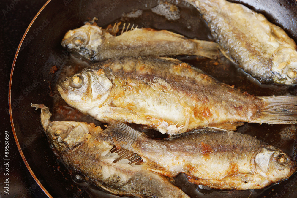 Fish is being fried on the frying pan Fish is being fried on the frying pan