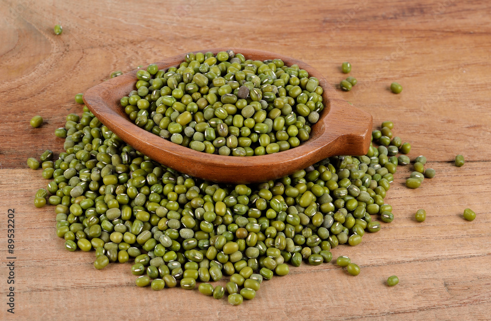 Green bean in wood spoon on wood background