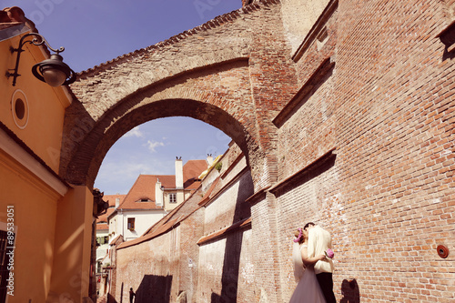 Bride and groom walking in old city