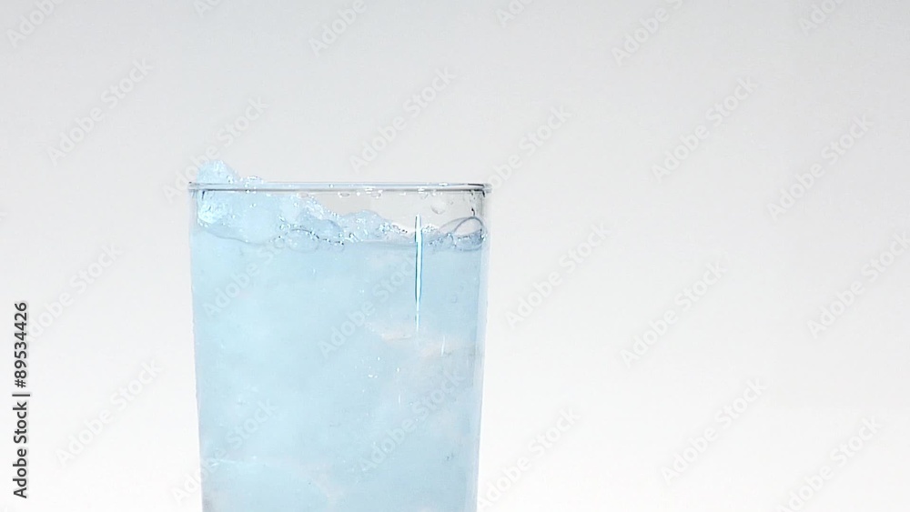 Pouring water into a glass of crushed ice Pouring water into a glass of crushed ice