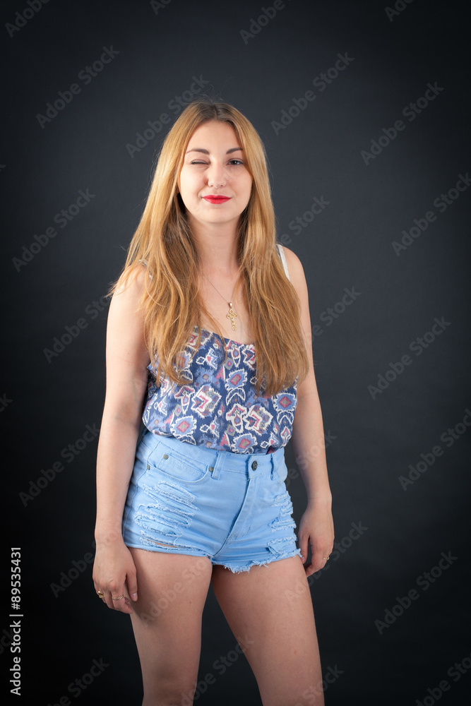 Fototapeta premium Beautiful girl doing different expressions in different sets of clothes: blinking