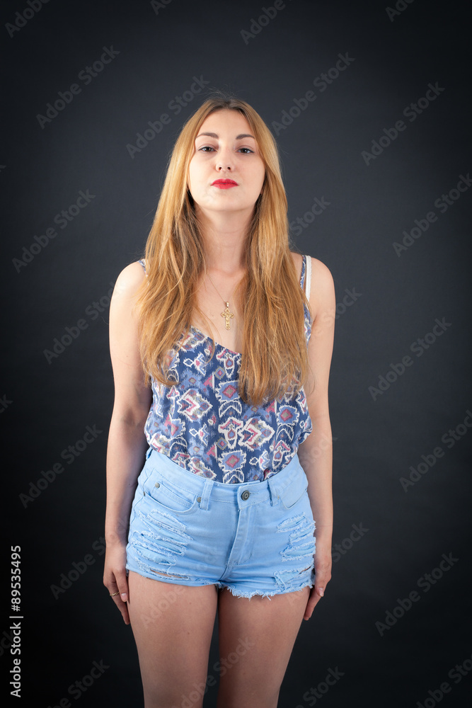 Beautiful girl doing different expressions in different sets of clothes: at attention Beautiful girl doing different expressions in different sets of clothes: at attention