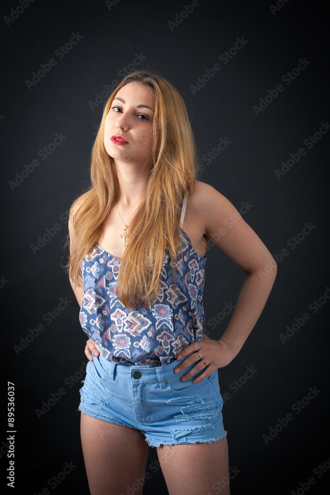 Beautiful girl doing different expressions in different sets of clothes: hands on hips Beautiful girl doing different expressions in different sets of clothes: hands on hips