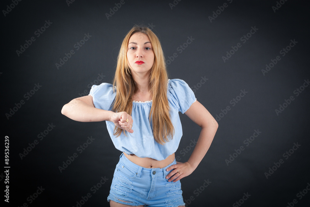 Beautiful girl doing different expressions in different sets of clothes: thumbs down