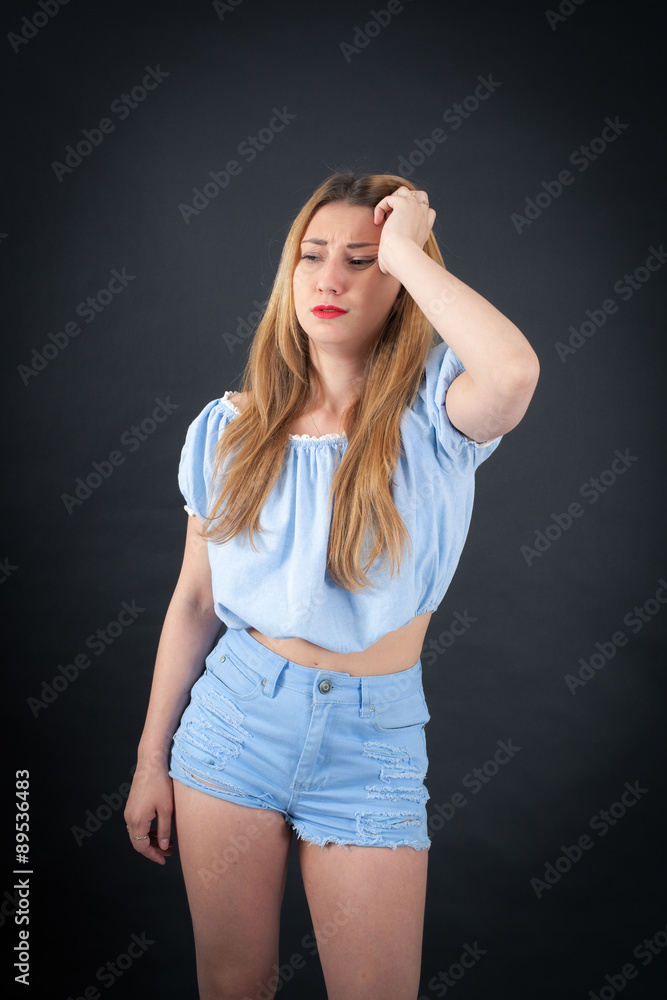 Beautiful girl doing different expressions in different sets of clothes: headache Beautiful girl doing different expressions in different sets of clothes: headache