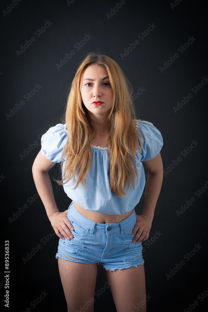 Beautiful girl doing different expressions in different sets of clothes: hands on hips Beautiful girl doing different expressions in different sets of clothes: hands on hips