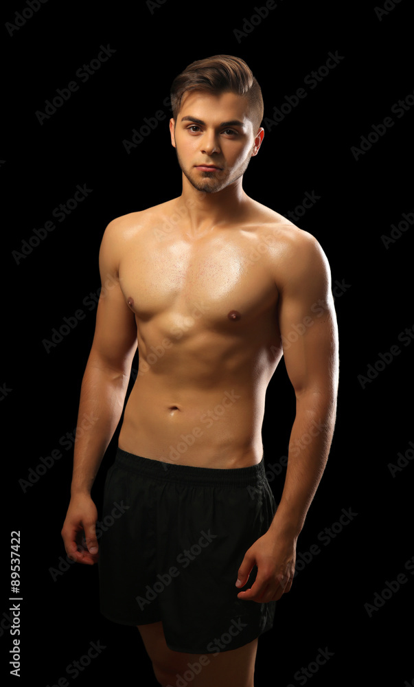 Fototapeta premium Muscle young man on dark background