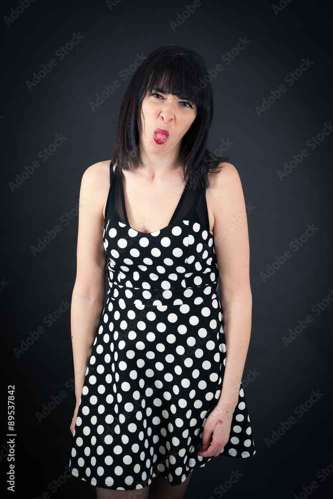 Beautiful woman doing different expressions in different sets of clothes: making a face Beautiful woman doing different expressions in different sets of clothes: making a face