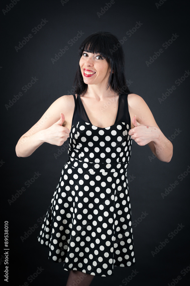 Beautiful woman doing different expressions in different sets of clothes: thumbs up Beautiful woman doing different expressions in different sets of clothes: thumbs up