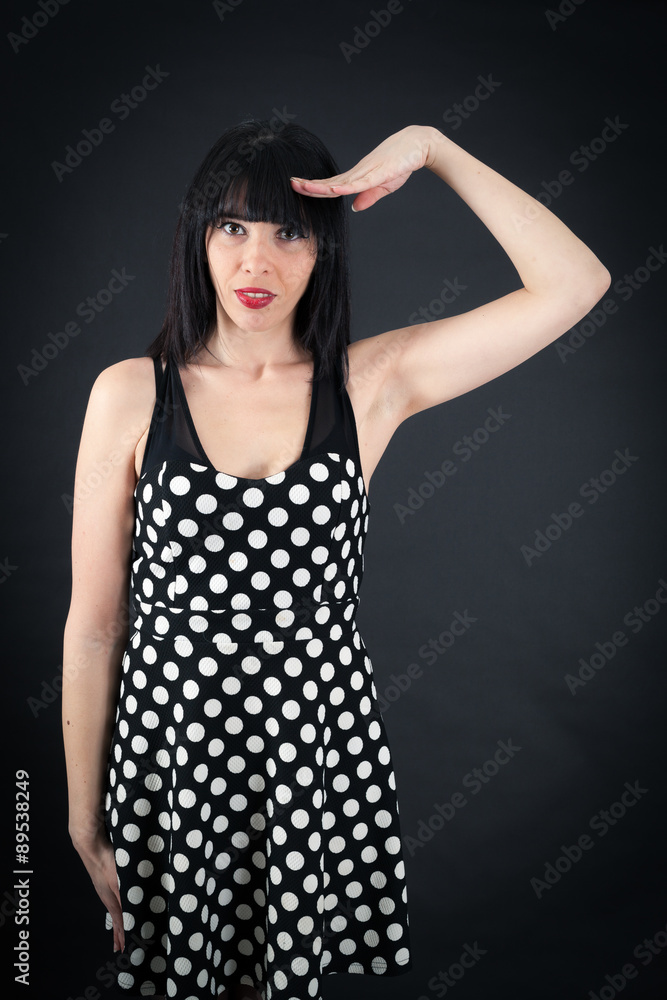 Beautiful woman doing different expressions in different sets of clothes: at attention