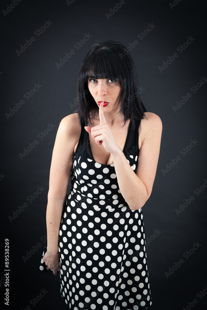 Beautiful woman doing different expressions in different sets of clothes: be quiet Beautiful woman doing different expressions in different sets of clothes: be quiet
